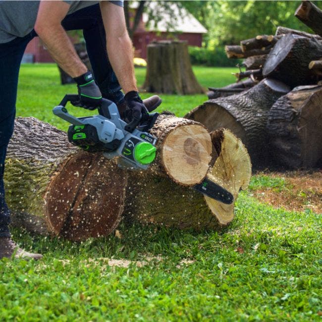 Cutting a log with an EGO chainsaw